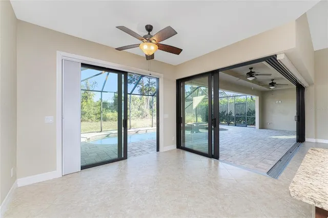 a large kitchen with stainless steel appliances kitchen island granite countertop a refrigerator a stove top oven a sink with island and chairs