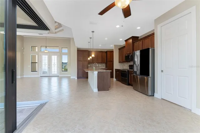 a view of a livingroom with a ceiling fan and window