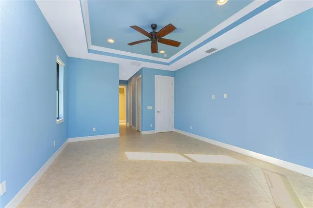 a bathroom with a granite countertop sink a toilet a large mirror and shower