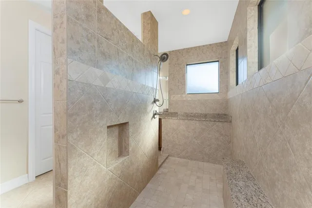 an empty room with closet and windows