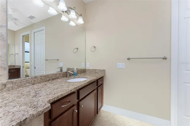 an empty room with a chandelier fan