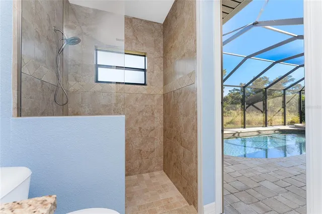 a view of a swimming pool with an outdoor space and seating area