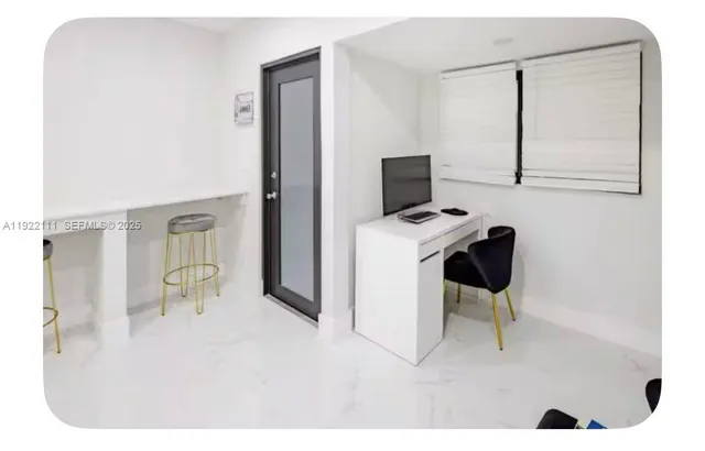 a workspace with furniture and mirror