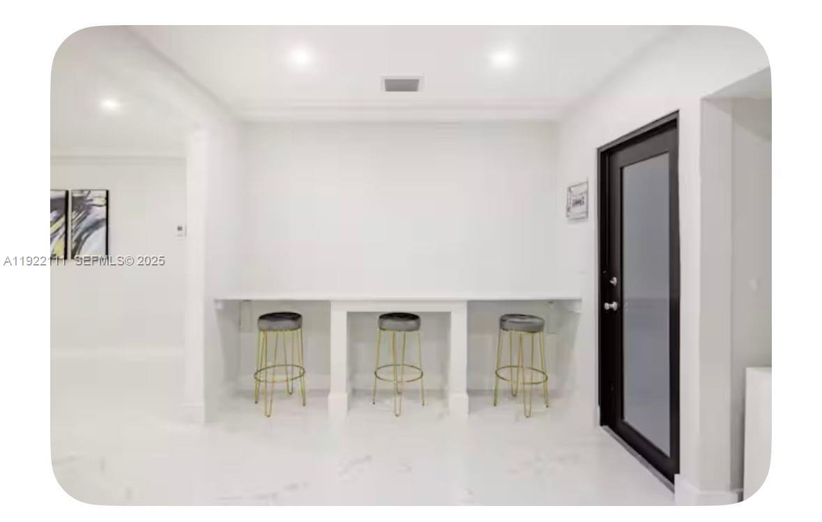 1301 Northwest 99th Street, Unit A Miami, FL 33147 - Photo 4 of 10 a living room with furniture and a table