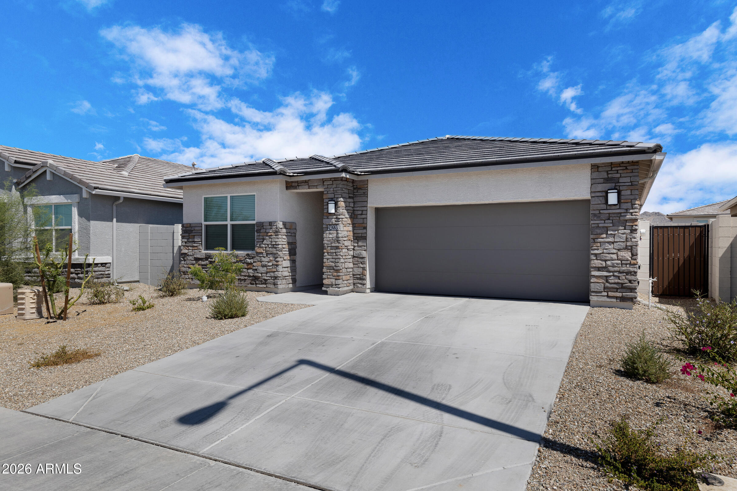 24220 West Ripple Road Buckeye, AZ 85326 - Photo 2 of 10 a front view of a house with patio