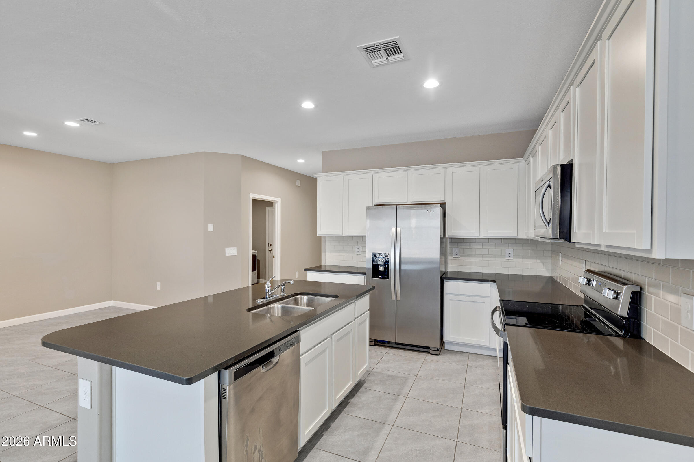 24220 West Ripple Road Buckeye, AZ 85326 - Photo 3 of 10 a kitchen with refrigerator and stove