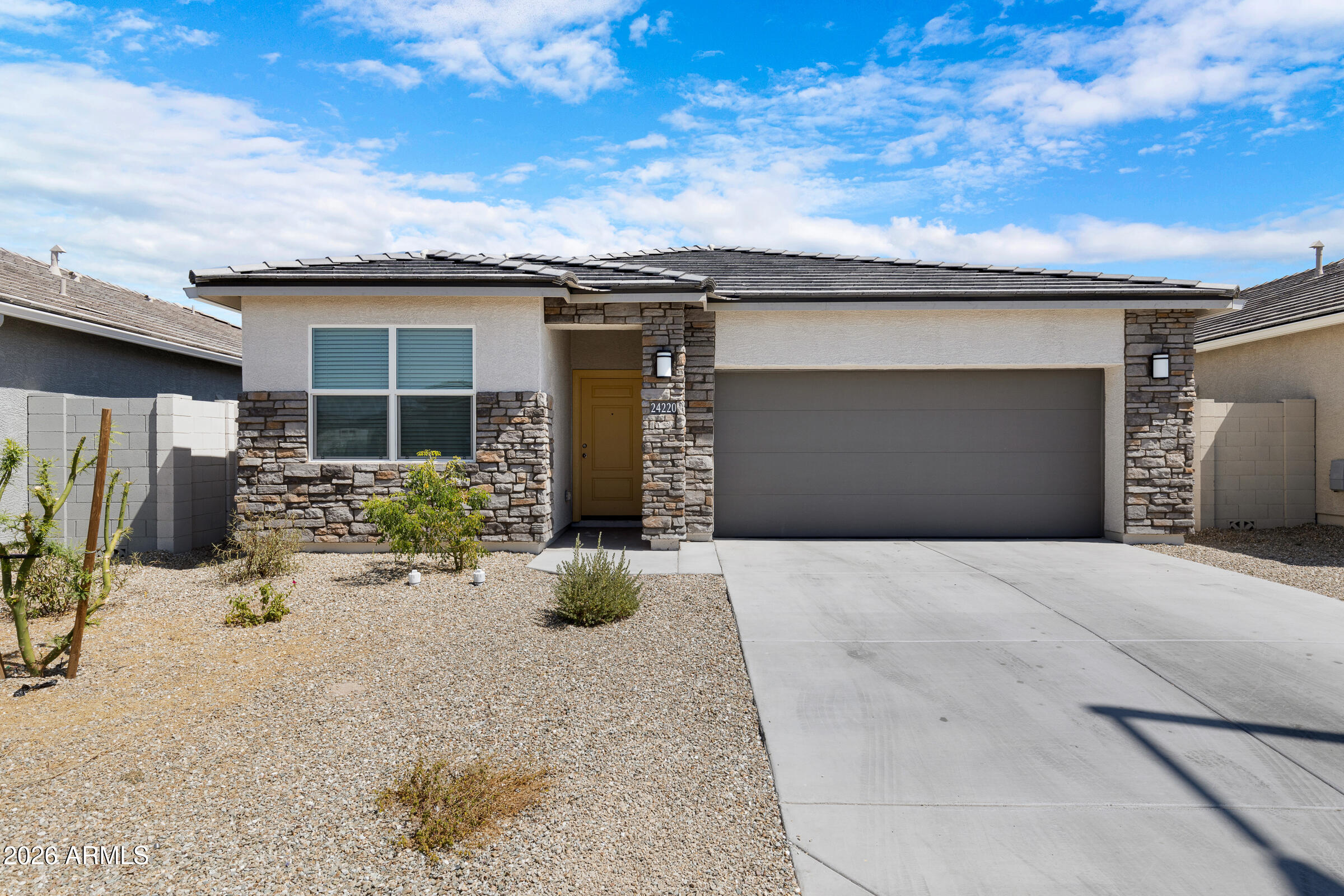 24220 West Ripple Road Buckeye, AZ 85326 - Photo 9 of 10 a front view of a house with a patio