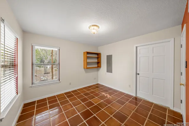 a bathroom with a granite countertop sink a mirror and shower