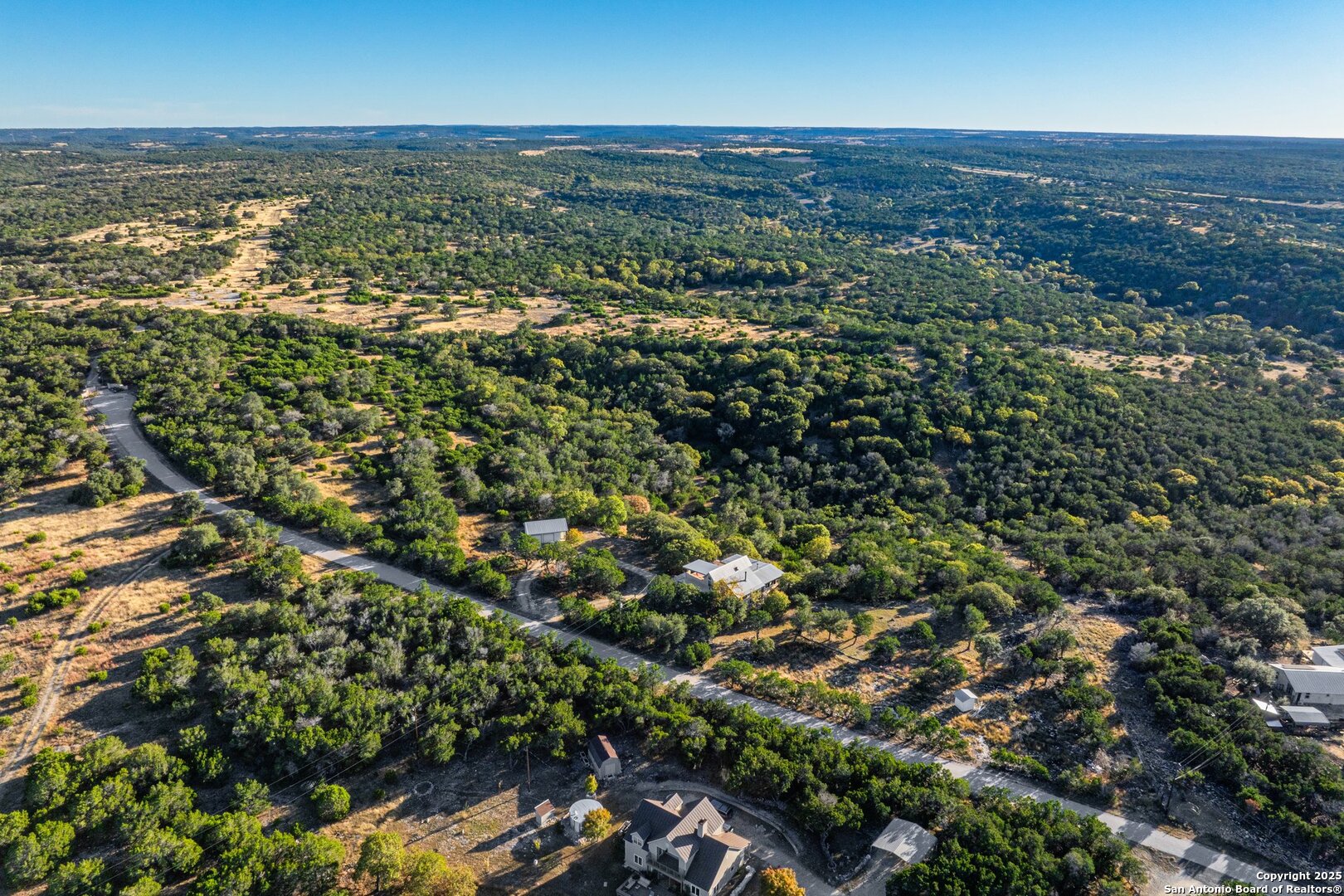125 Turkey Trot Trail Southwest Hunt, TX 78024 - Photo 3 of 40 an aerial view of residential houses with outdoor space and trees