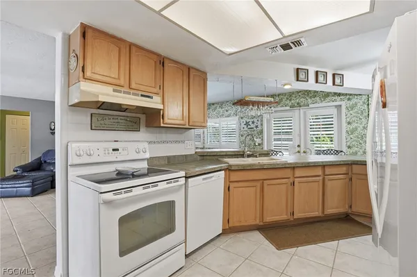 a kitchen with stainless steel appliances granite countertop a stove sink and cabinets