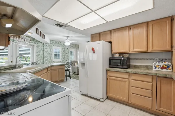 a kitchen with refrigerator and cabinets