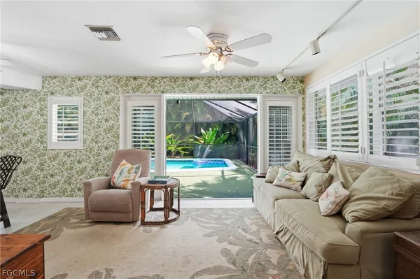a living room with furniture and a large window