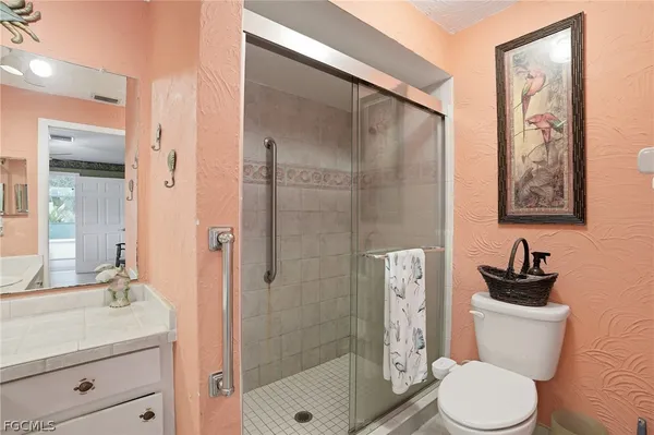 a bathroom with a toilet sink and shower