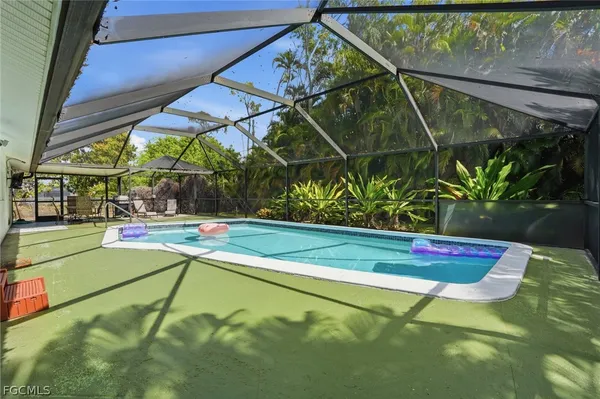 a view of a backyard with swimming pool