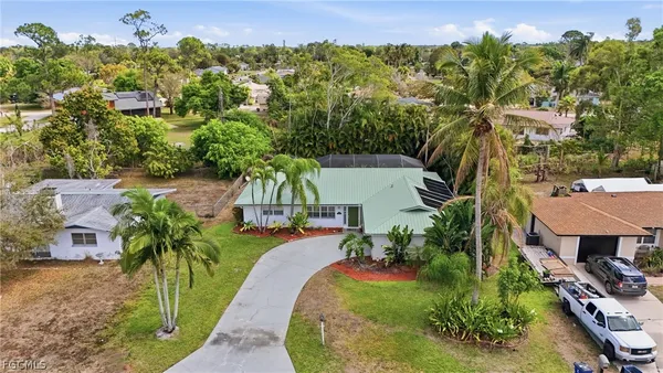 an aerial view of a house with a yard basket ball court and outdoor seating