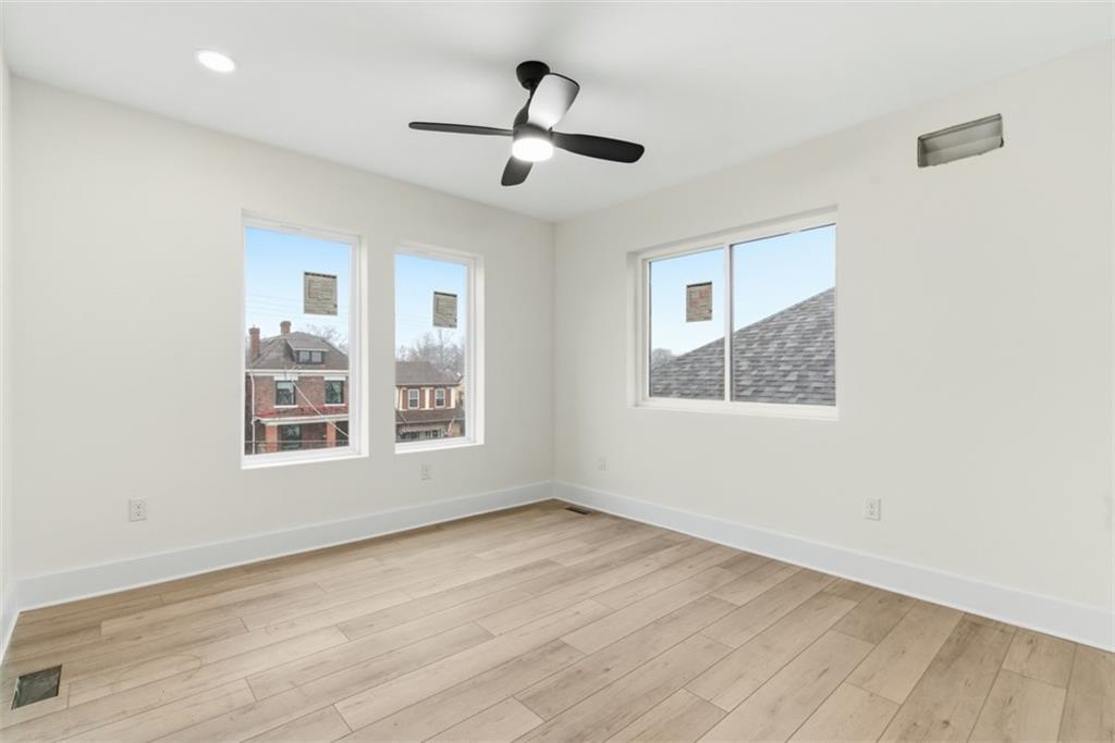 1361 Hawthorne Street Pittsburgh, PA 15201 - Photo 23 of 50 a view of an empty room with wooden floor and a window