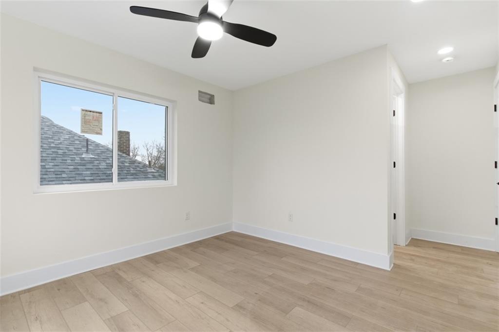 1361 Hawthorne Street Pittsburgh, PA 15201 - Photo 24 of 50 an empty room with a window and ceiling fan