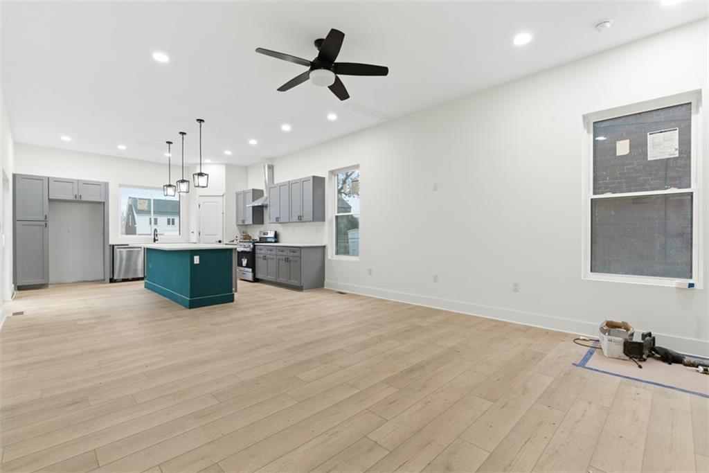 1361 Hawthorne Street Pittsburgh, PA 15201 - Photo 5 of 50 a kitchen with stainless steel appliances kitchen island a refrigerator sink and cabinets