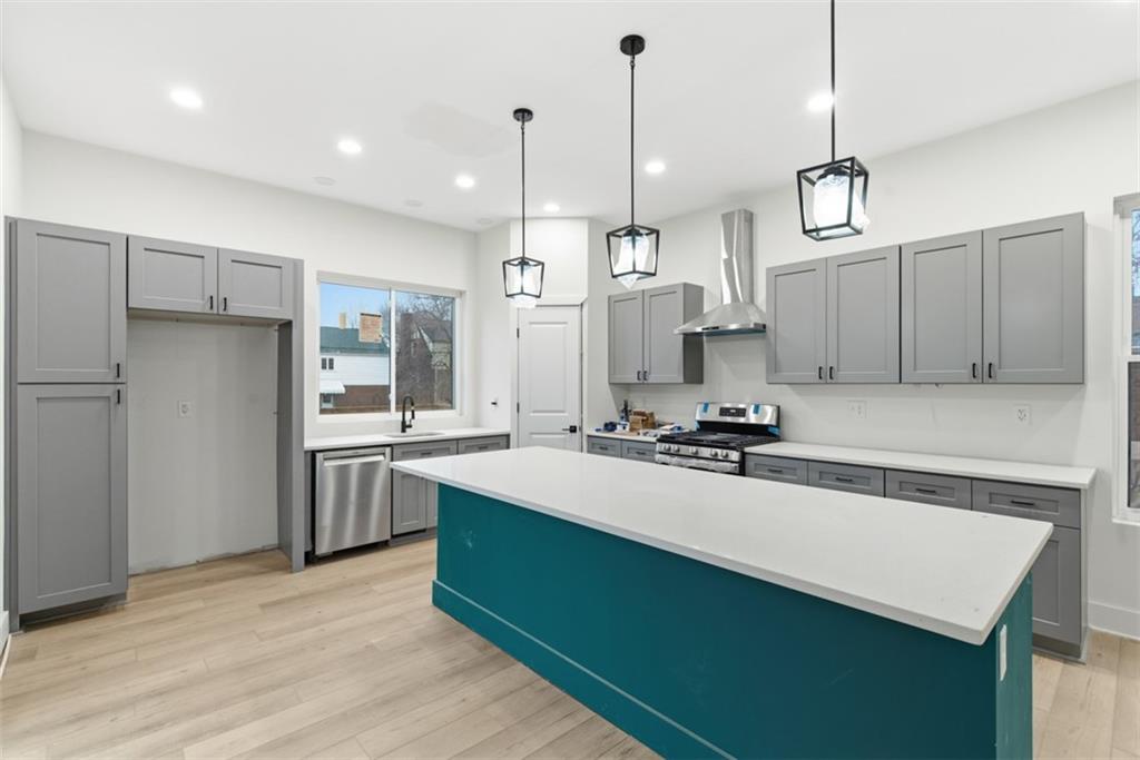 1361 Hawthorne Street Pittsburgh, PA 15201 - Photo 8 of 50 a kitchen with stainless steel appliances a sink stove and refrigerator