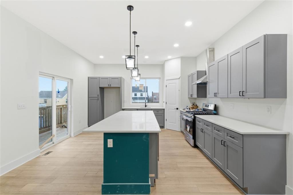 1361 Hawthorne Street Pittsburgh, PA 15201 - Photo 9 of 50 a kitchen with stainless steel appliances kitchen island granite countertop a refrigerator a sink dishwasher and a wooden cabinets