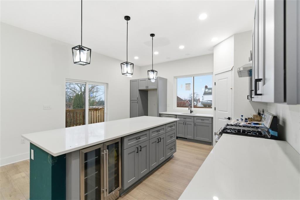 1361 Hawthorne Street Pittsburgh, PA 15201 - Photo 10 of 50 a kitchen with a sink a counter top space and stainless steel appliances