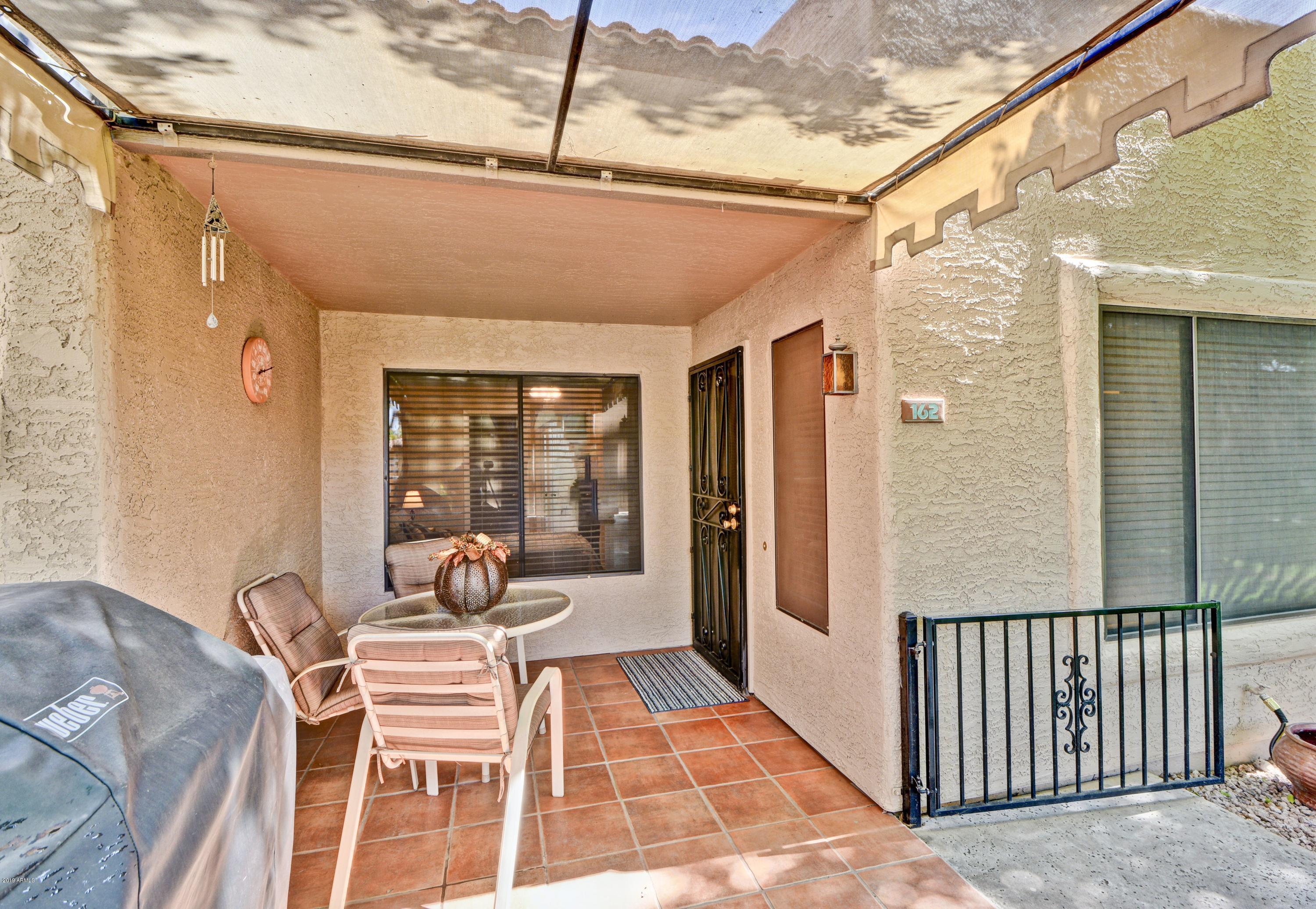 14300 West Bell Road, Unit 162 Surprise, AZ 85374 - Photo 13 of 23 a balcony with furniture and a potted plant
