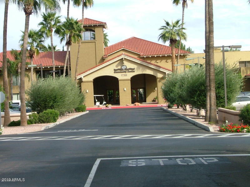 14300 West Bell Road, Unit 162 Surprise, AZ 85374 - Photo 16 of 23 a front view of house with yard along with palm trees