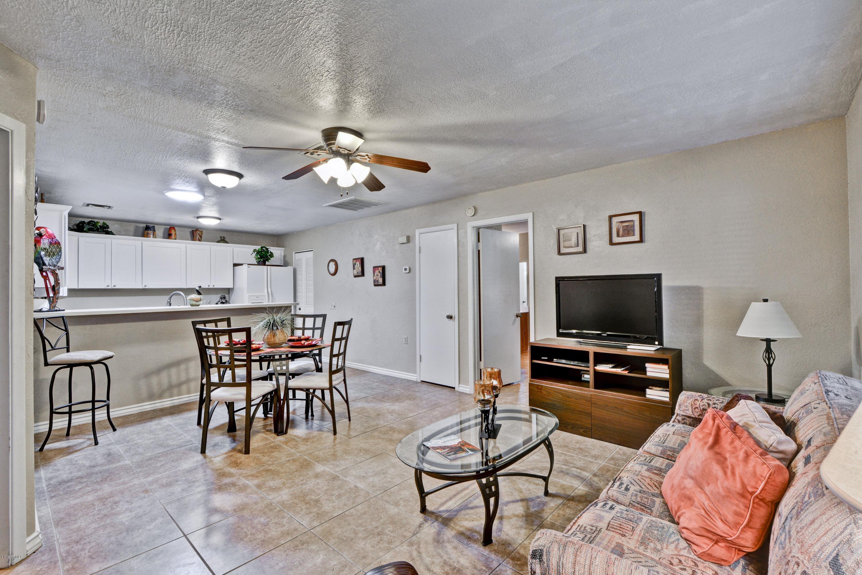 14300 West Bell Road, Unit 162 Surprise, AZ 85374 - Photo 2 of 23 a view of a livingroom with furniture and a flat screen tv