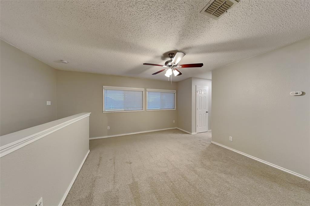 308 Cortland Circle Roanoke, TX 76262 - Photo 17 of 21 a view of an empty room with a chandelier fan