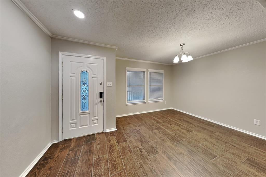 308 Cortland Circle Roanoke, TX 76262 - Photo 2 of 21 an empty room with wooden floor and mirror