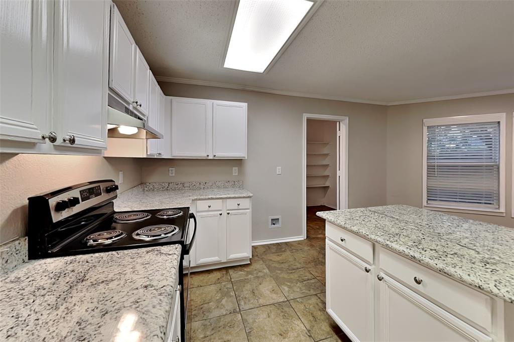 308 Cortland Circle Roanoke, TX 76262 - Photo 7 of 21 a kitchen with a stove and a refrigerator