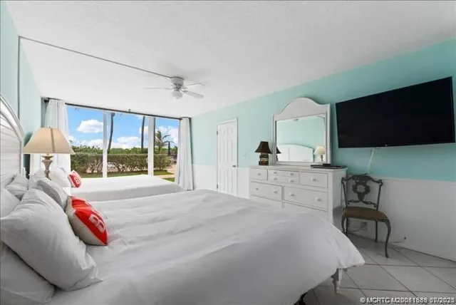 a bedroom with a bed and large window