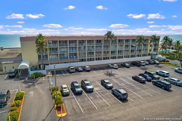 a front view of a house with swimming pool and furniture