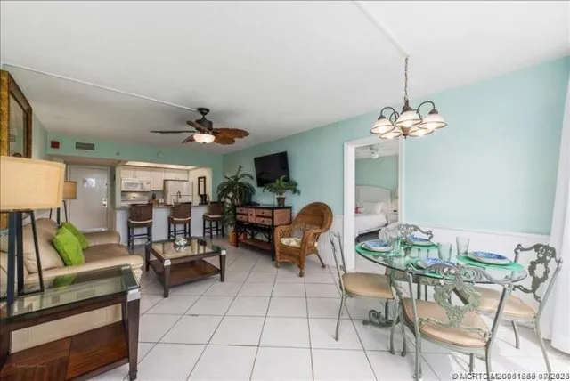 a living room filled with furniture and a chandelier