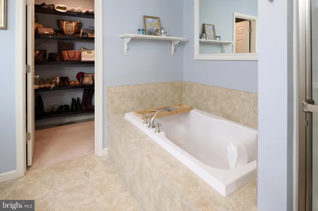 a roof deck with chairs and wooden floor