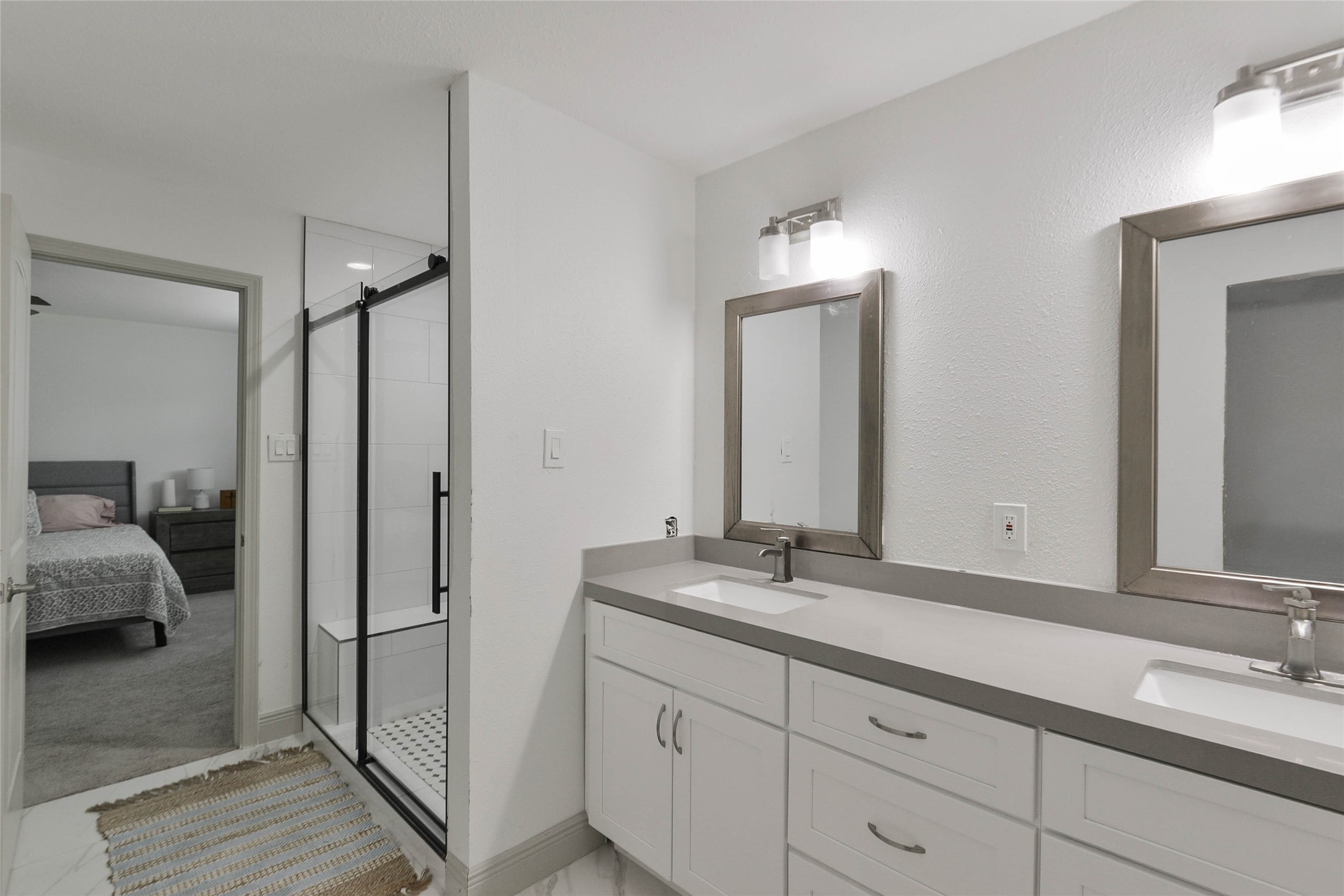 531 Brandon Road Conroe, TX 77302 - Photo 17 of 33 a en suite bathroom with a double vanity sink and a mirror