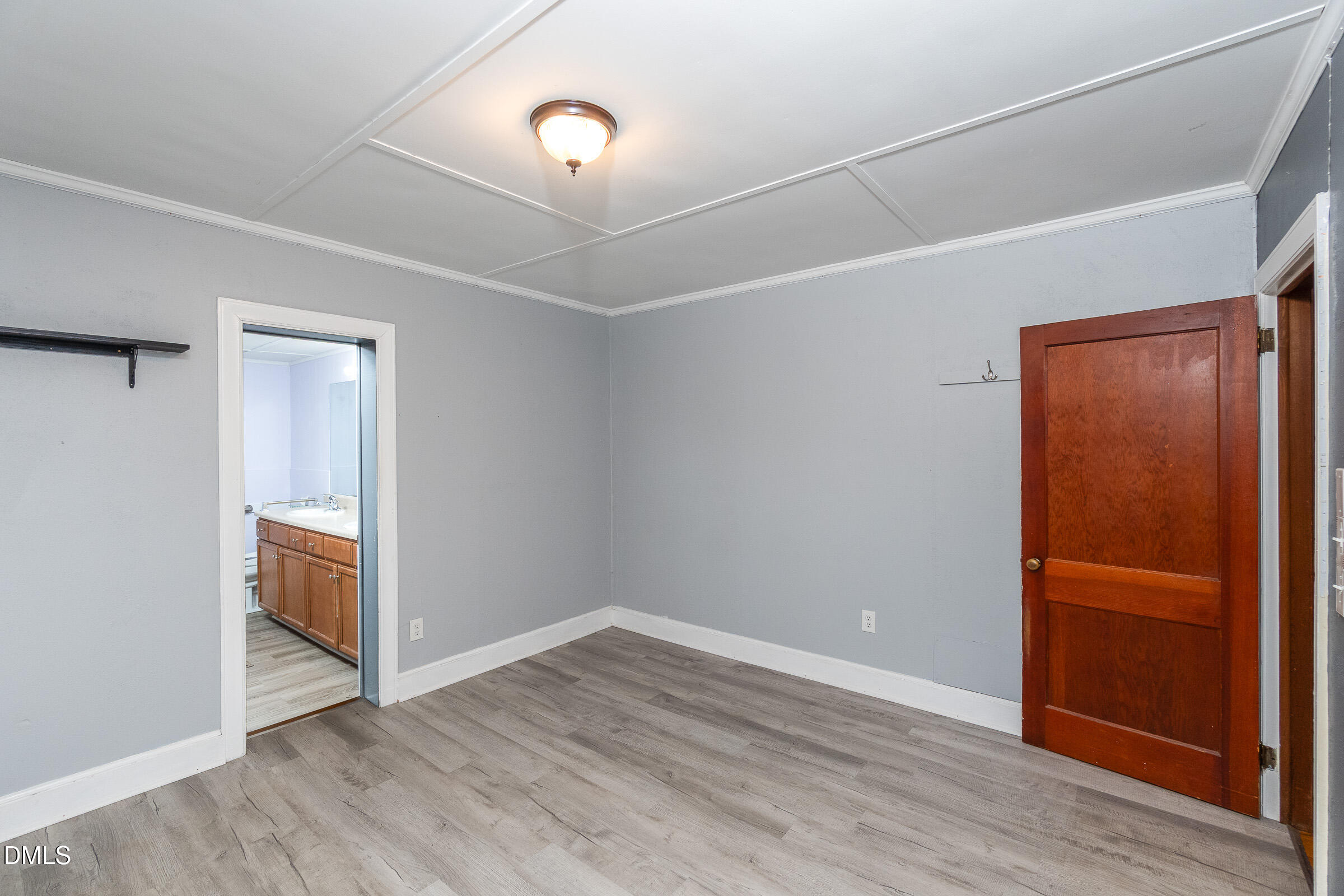 704 Pearces Road Zebulon, NC 27597 - Photo 15 of 26 an empty room with wooden floor and windows