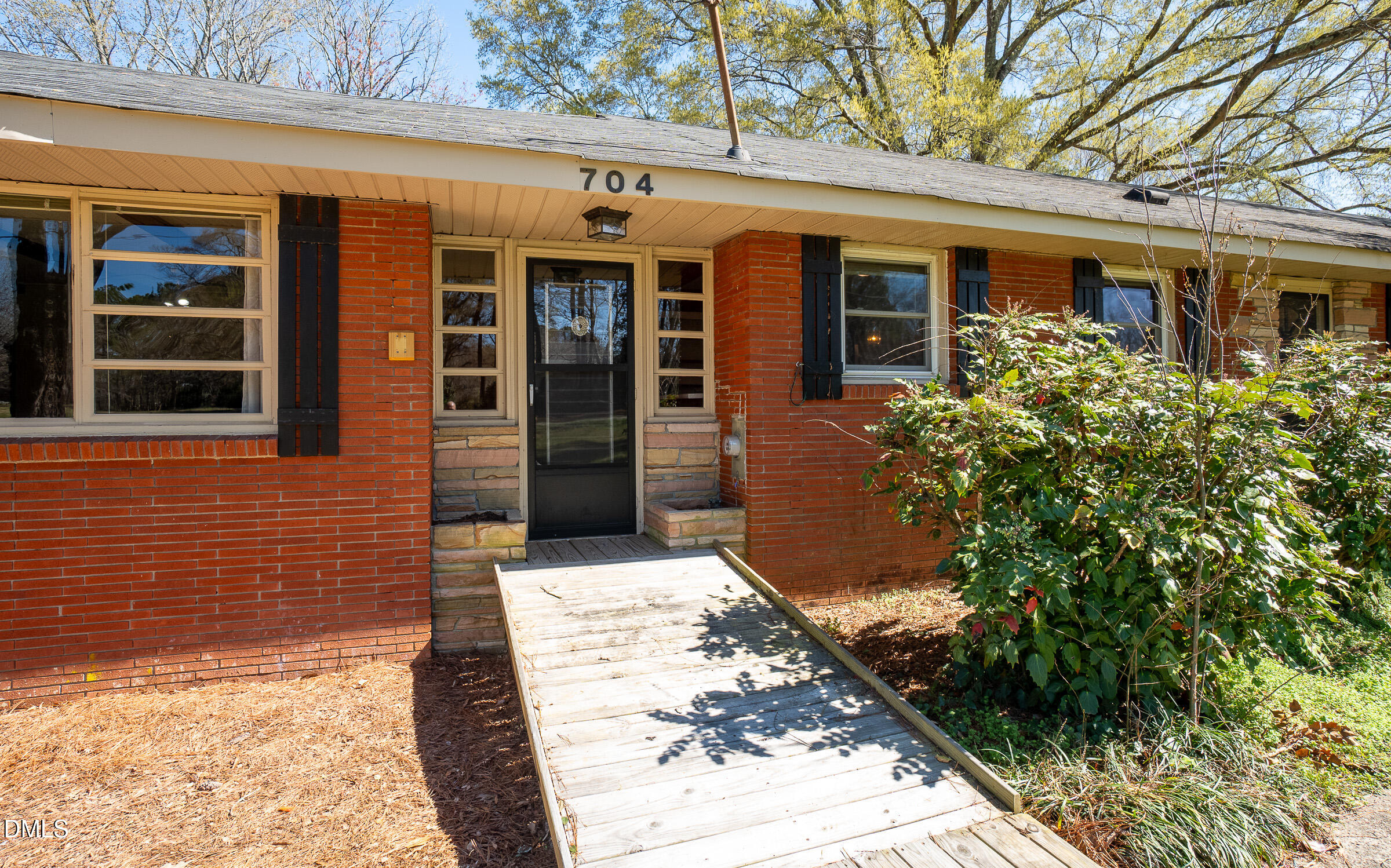 704 Pearces Road Zebulon, NC 27597 - Photo 2 of 26 front view of a brick house with a large window