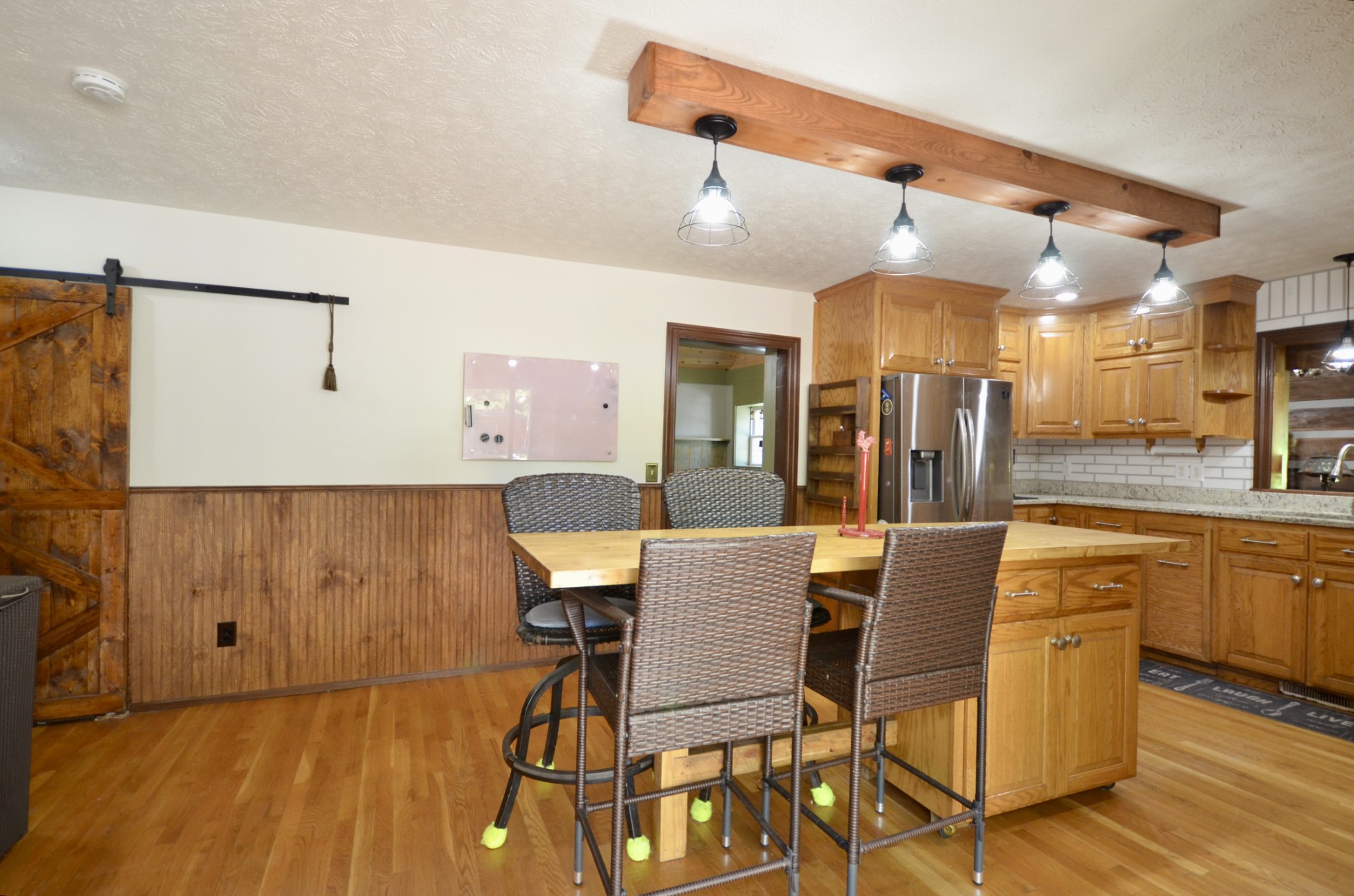 1355 Westfield Road Dickson, TN 37055 - Photo 37 of 83 a dining hall with stainless steel appliances a dining table and chairs with wooden floor