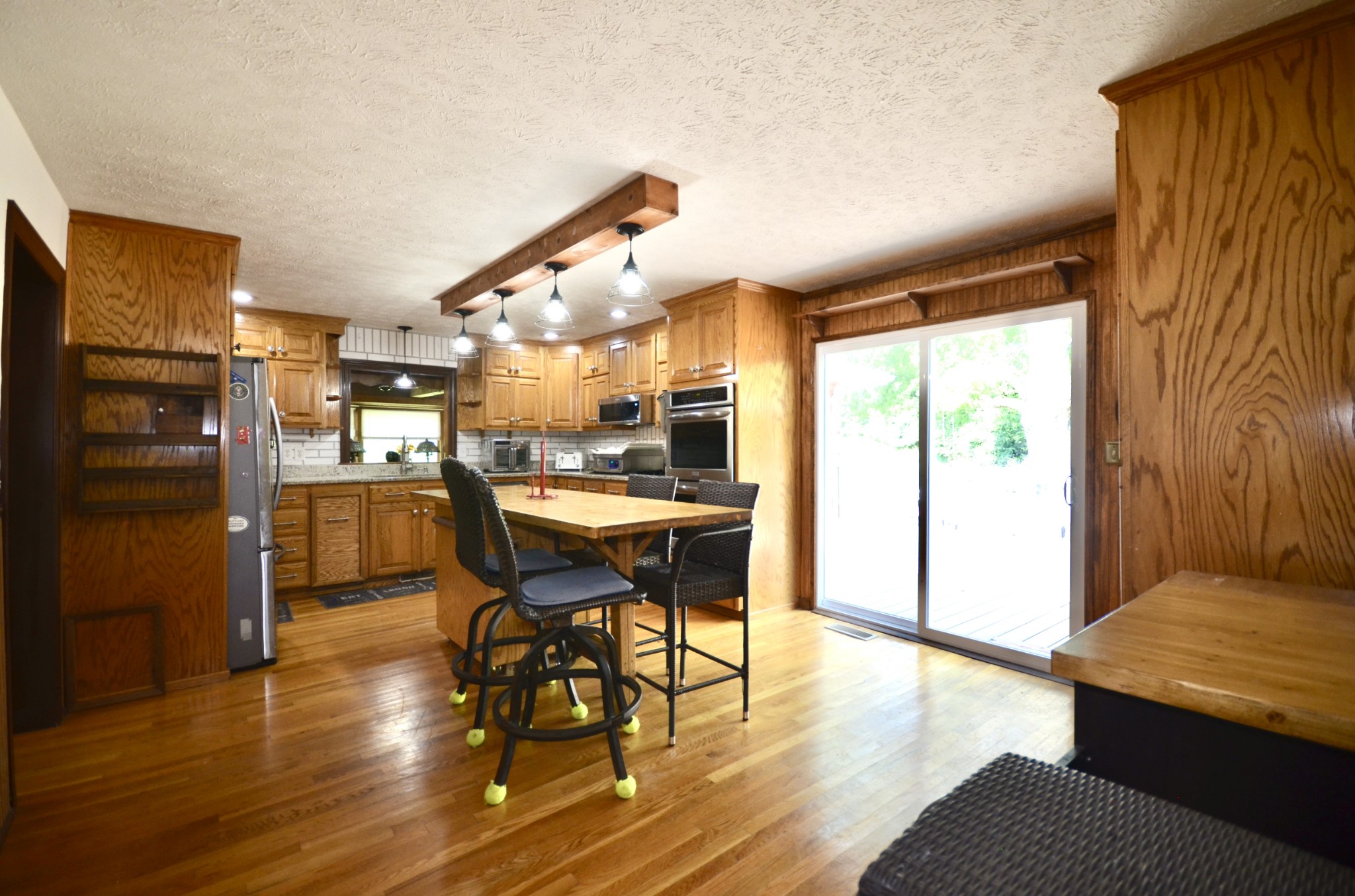 1355 Westfield Road Dickson, TN 37055 - Photo 38 of 83 a kitchen with stainless steel appliances granite countertop a refrigerator a sink dishwasher a dining table and chairs with wooden floor