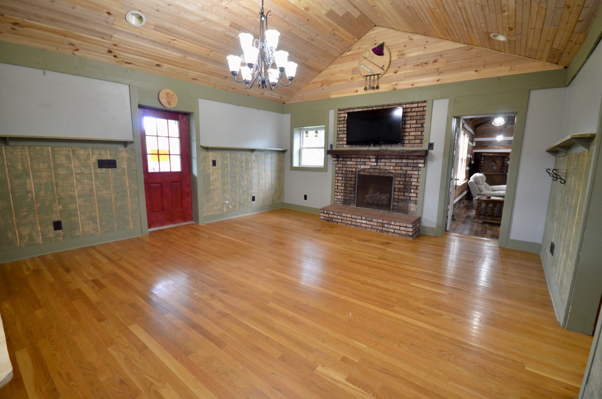 1355 Westfield Road Dickson, TN 37055 - Photo 43 of 83 a view of a livingroom with a fireplace a chandelier and wooden floor