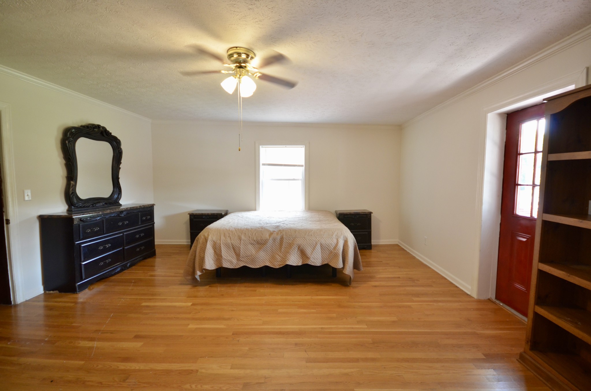 1355 Westfield Road Dickson, TN 37055 - Photo 57 of 83 a spacious bedroom with a bed and wooden floor