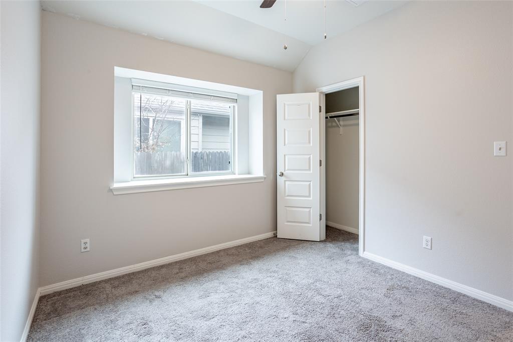 615 Stampede Road San Marcos, TX 78666 - Photo 5 of 26 A cozy retreat with high ceilings, a wide window, and plush carpeting awaits.