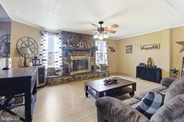 a living room with furniture a fireplace and a flat screen tv
