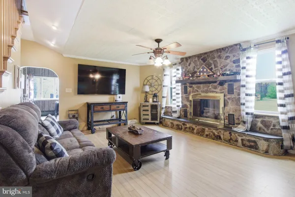 a living room with furniture a fireplace and a flat screen tv
