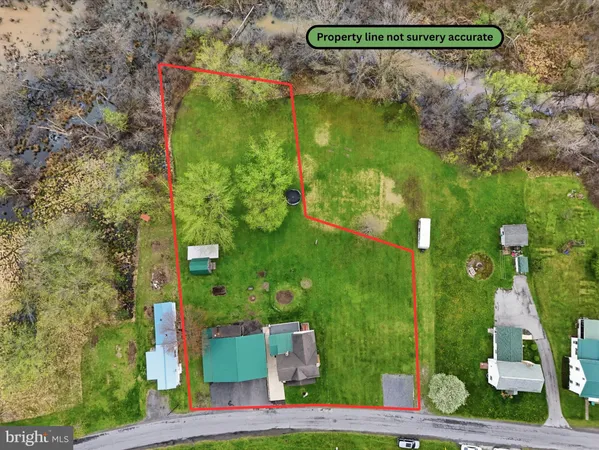 an aerial view of a house with a yard basket ball court and outdoor seating