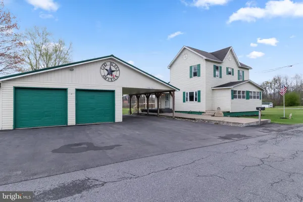 a view of a house with a yard and garage