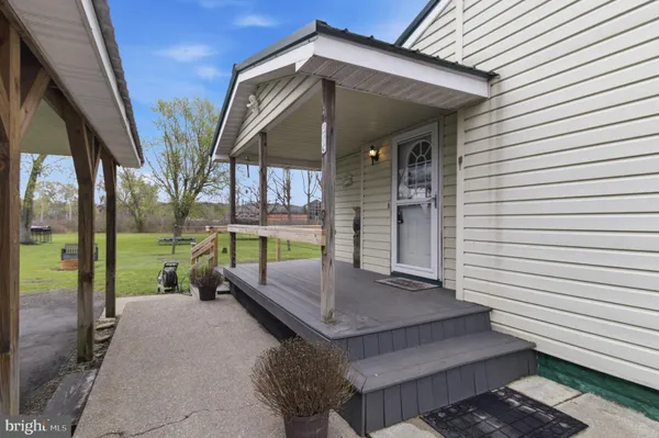 a view of backyard with deck and outdoor seating