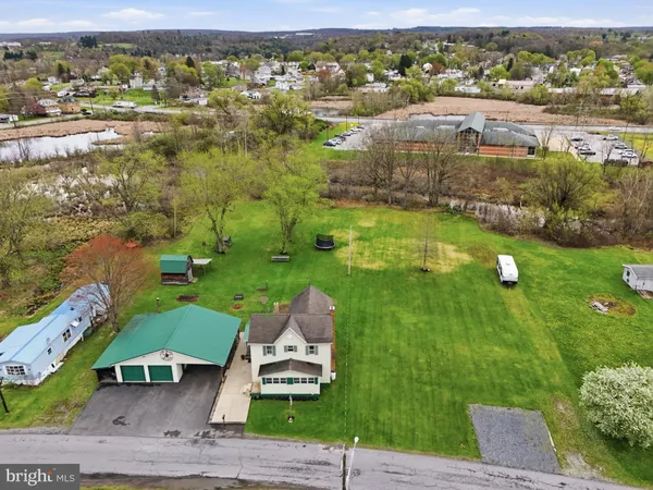 an aerial view of residential houses with outdoor space and river