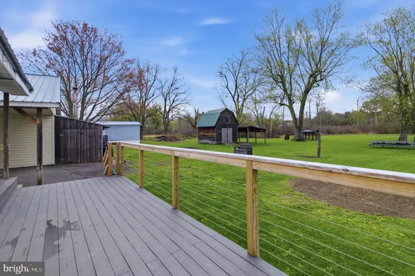 a view of a wooden deck with a yard